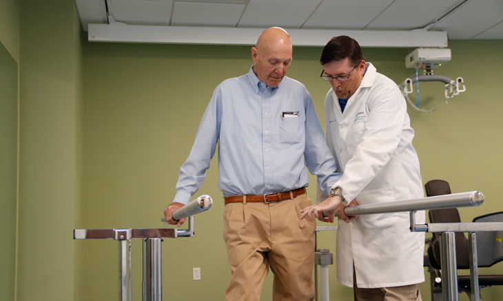 Doctor helping patient during rehab session